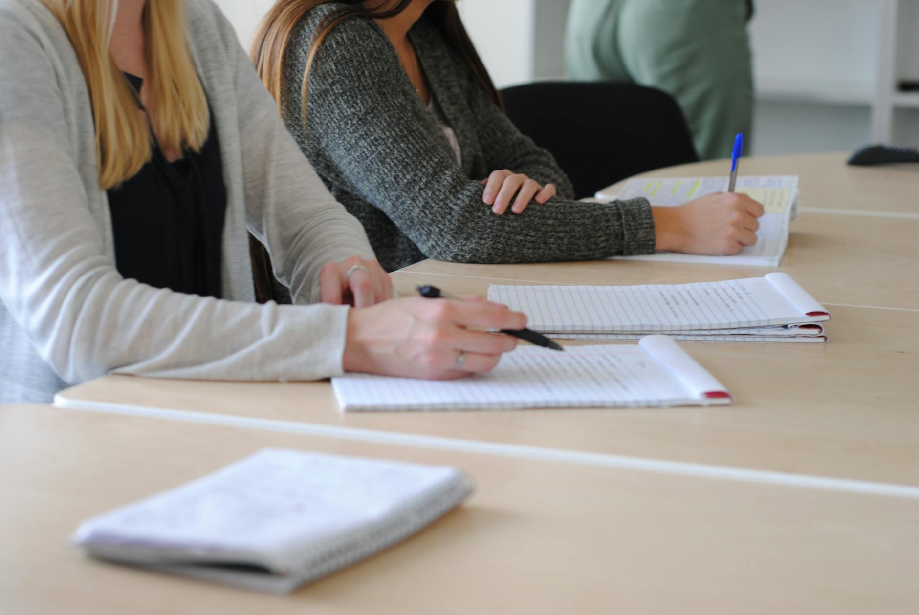 people holding pens while at a neuroaffirming trauma-informed CEU