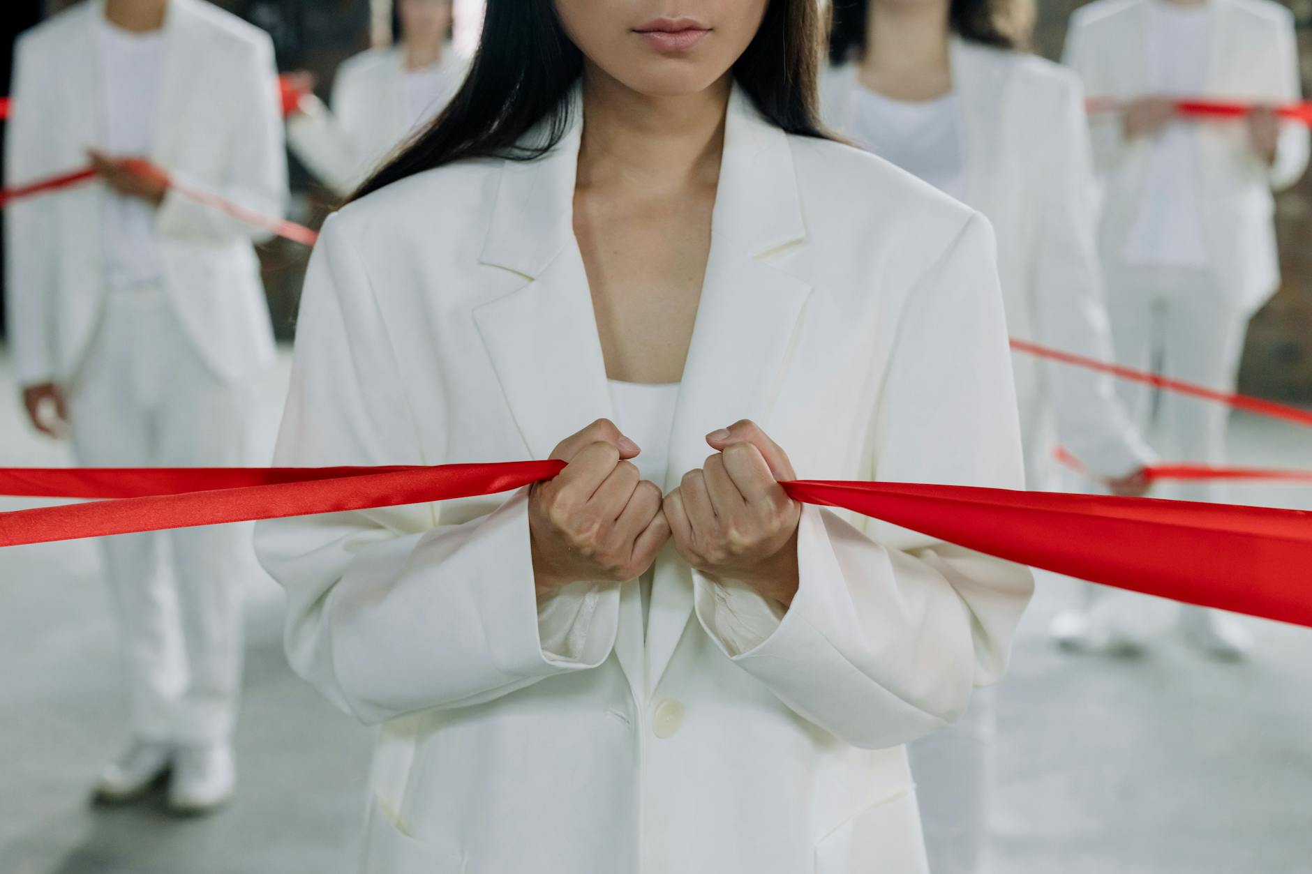 woman in white suit holding red ribbon autistic clinical strategies for unmasking ceu