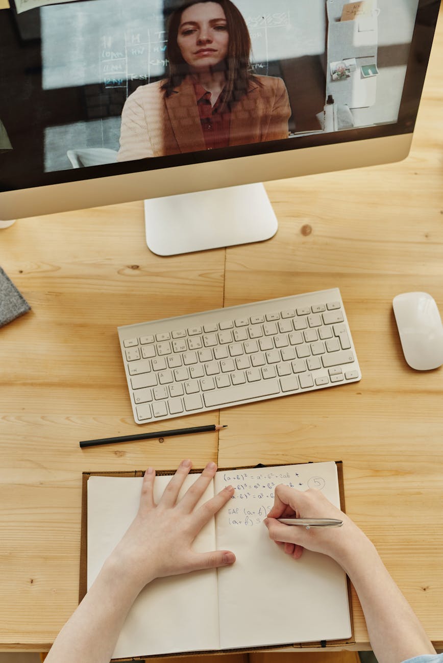 person writing on notebook on-demand clinical training for therapists